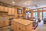 Large kitchen with granite countertops and island with bar seating